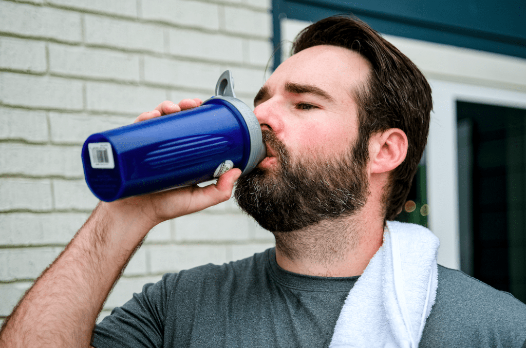 Drinking a protein shake after a Community Strength Austin personal training workout.