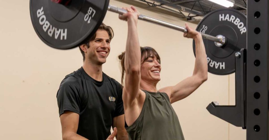 John is helping a woman in training