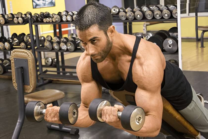 A guy doing decline bicep curls.