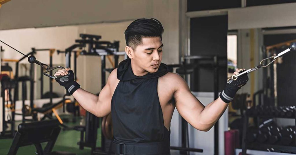 A man doing crucifix curls