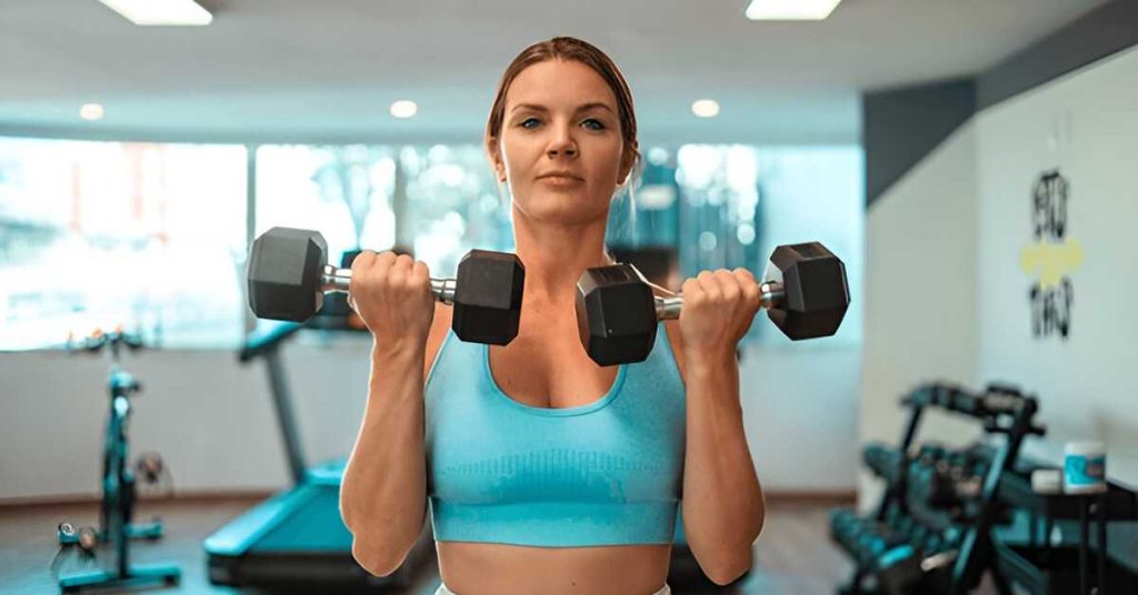A woman performing 21s bicep curls