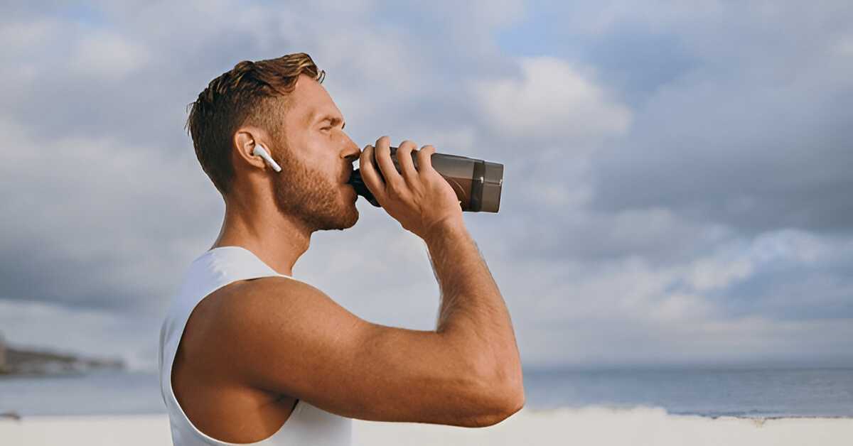 A man in Austin drinking water in summer after a workout