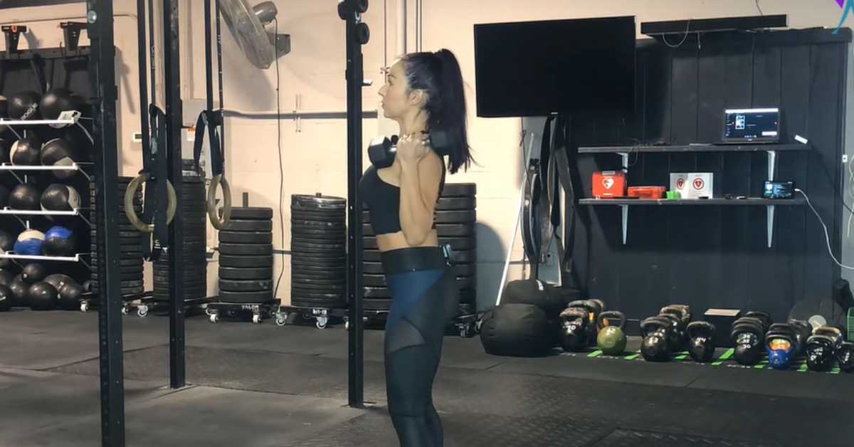 A woman performing a lateral bicep curl.